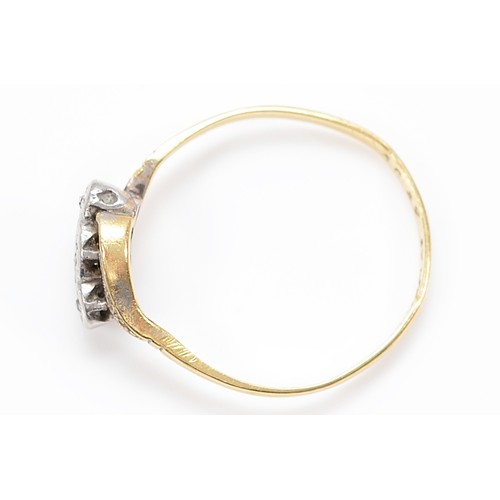 11 - An 18ct gold and platinum diamond three stone cross over ring, N, 1.5g