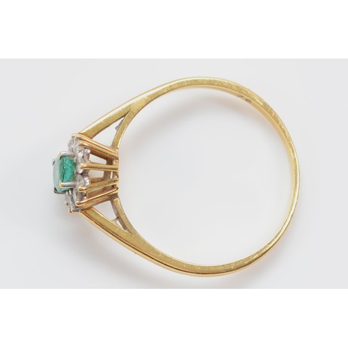 26 - An 18ct gold emerald and brilliant cut diamond cluster ring, Birmingham 1987, S, 2.7g