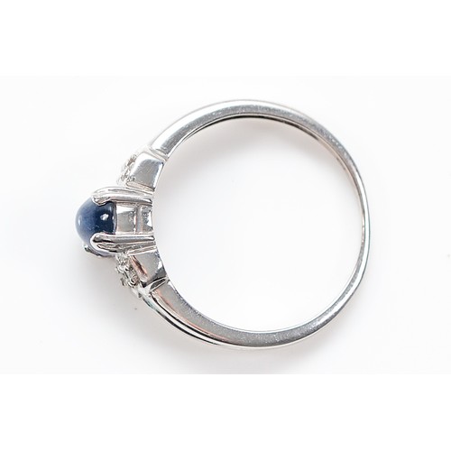29 - A 9ct white gold sapphire cabochon and diamond dress ring, Birmingham 2005, N 1/2, 2.7g