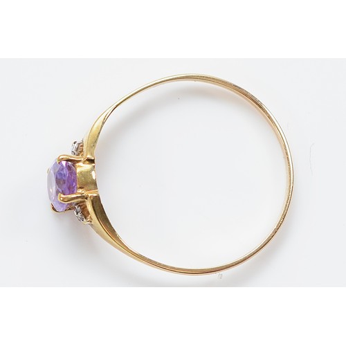 33 - An unmarked 9ct gold amethyst and diamond three stone ring, Q, 1g