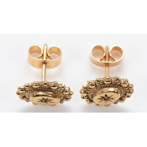 49 - A pair of unmarked 9ct gold and brilliant cut diamond earrings with scroll backs, 1.6g