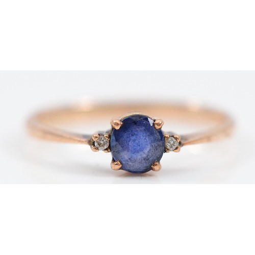 55 - A 14K gold sapphire and brilliant cut diamond three stone ring, M, 1.5g