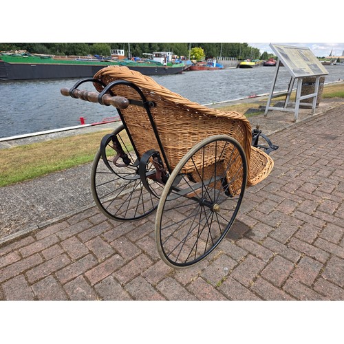  Wickerwork bath chair, with wrought metal frame, early 20th century, solid rubber tyres, spring seat... 