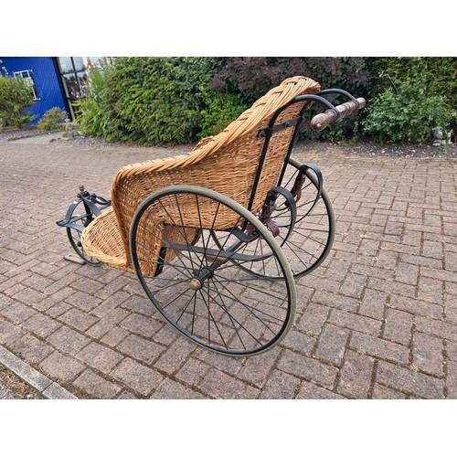  Wickerwork bath chair, with wrought metal frame, early 20th century, solid rubber tyres, spring seat... 