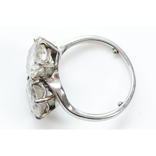  A circa 1940 unmarked platinum two stone cross over ring, two early brilliant cut diamonds weighed o... 
