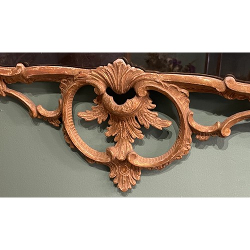 452 - A pair of George III giltwood mirrors, with later plates, each carved with waved pierced rectangular... 