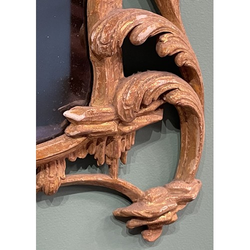 452 - A pair of George III giltwood mirrors, with later plates, each carved with waved pierced rectangular... 