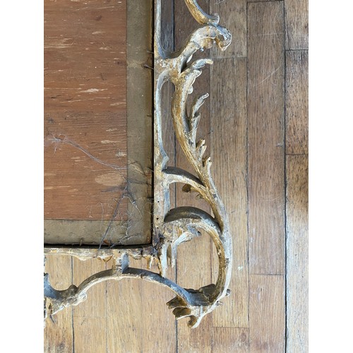 452 - A pair of George III giltwood mirrors, with later plates, each carved with waved pierced rectangular... 