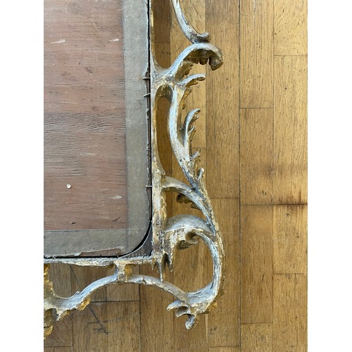 452 - A pair of George III giltwood mirrors, with later plates, each carved with waved pierced rectangular... 