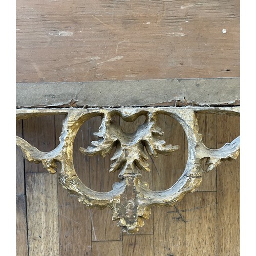 452 - A pair of George III giltwood mirrors, with later plates, each carved with waved pierced rectangular... 