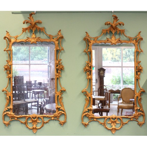 452 - A pair of George III giltwood mirrors, with later plates, each carved with waved pierced rectangular... 