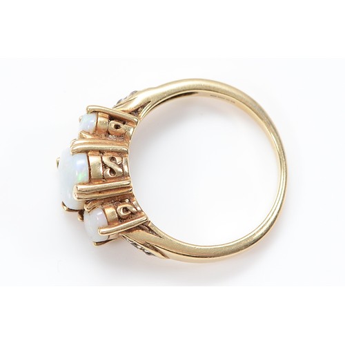 7 - A 9ct gold opal three stone ring with diamond set shoulders, Birmingham 2007, one opal is chipped, N... 