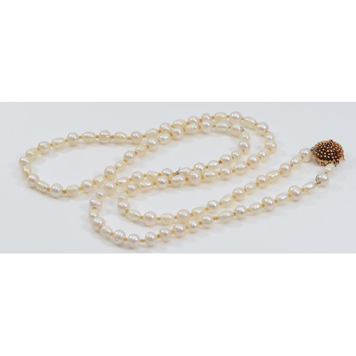 10 - A 585 gold and ruby clasped cultured pearl necklace, 96cm, clasp weighs approximately 7g