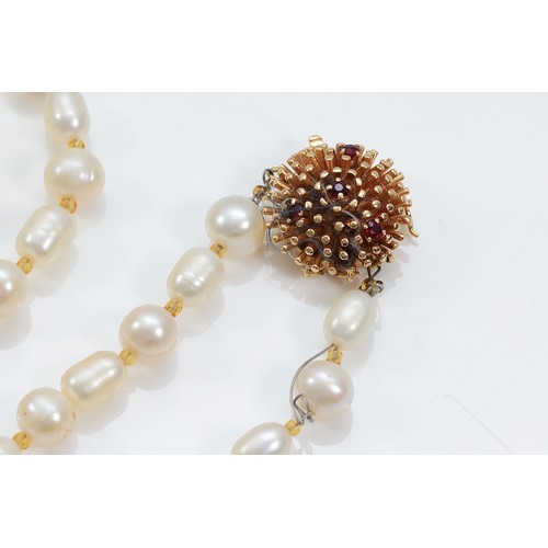 10 - A 585 gold and ruby clasped cultured pearl necklace, 96cm, clasp weighs approximately 7g