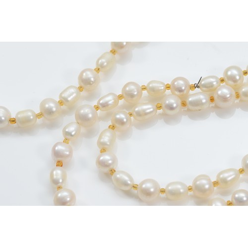 10 - A 585 gold and ruby clasped cultured pearl necklace, 96cm, clasp weighs approximately 7g