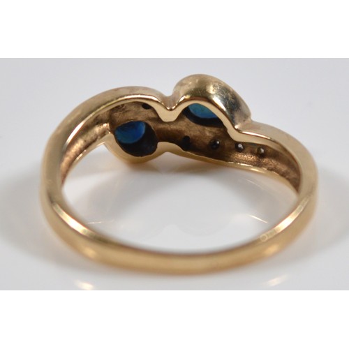 15 - An unmarked 9ct gold sapphire and single cut diamond cross over ring, hallmarks missing due to possi... 