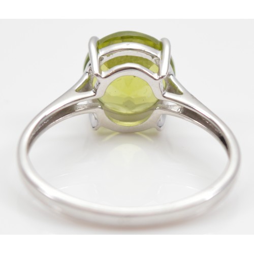 17 - A TGGC 9ct white gold peridot solitaire ring, Birmingham 2014, Q, 2.6g