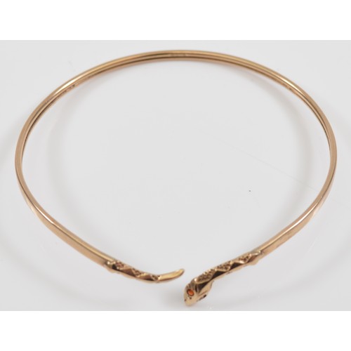 26 - A 9ct gold snake bangle, with garnet eyes, 67mm, 4.7g