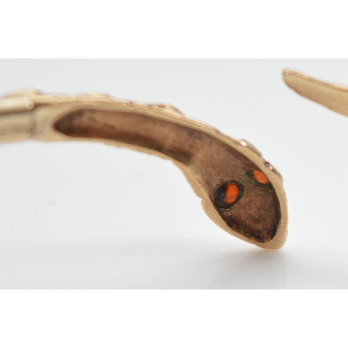 26 - A 9ct gold snake bangle, with garnet eyes, 67mm, 4.7g