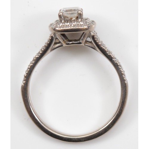 41 - An 18ct white gold diamond cluster ring, claw set with a Princess cut stone weighing approximately 0... 