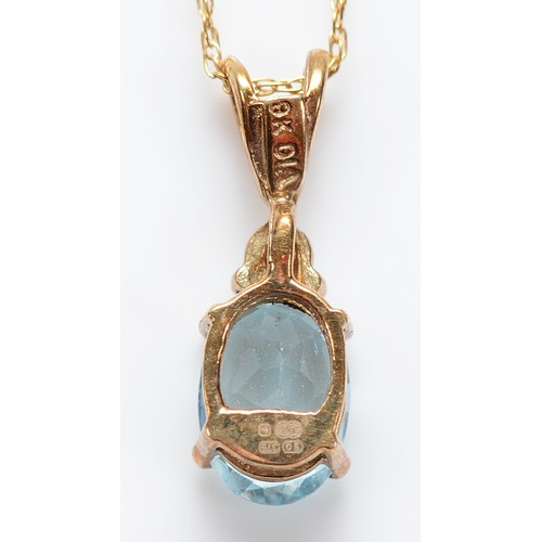 51 - A 9ct gold single cut diamond and blue topaz pendant on a chain, 1.1g