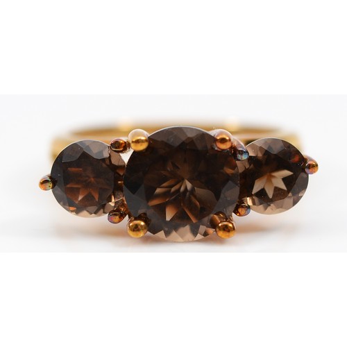 56 - A 9ct gold smokey quartz three stone ring, Birmingham 2007, N, 3.7g