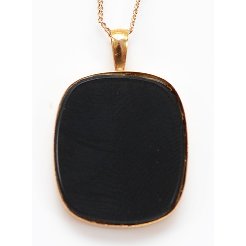 58 - A 9ct gold black onyx pendant with an opal butterfly inlay, on a chain, 1.8g