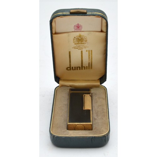 Alfred Dunhill, London; A 1970s Dunhill Rollagas pocket cigarette lighter, gold plated with black lacquer panels, in original presentation case with instruction booklet.