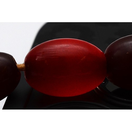 52 - A cherry Bakelite beaded necklace, largest bead 15mm, 46cm, screw closure, 23g