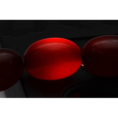53 - A cherry Bakelite beaded necklace, graduating bead size, largest bead 13mm, screw closure, 46cm, 22g