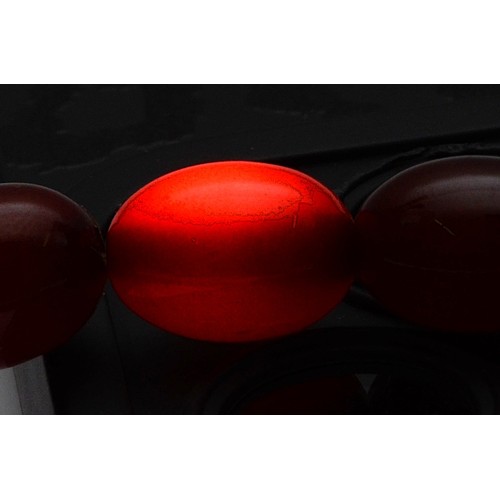 53 - A cherry Bakelite beaded necklace, graduating bead size, largest bead 13mm, screw closure, 46cm, 22g