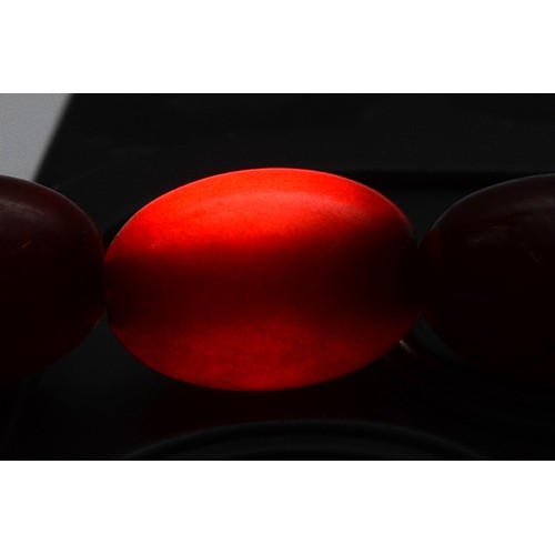 53 - A cherry Bakelite beaded necklace, graduating bead size, largest bead 13mm, screw closure, 46cm, 22g