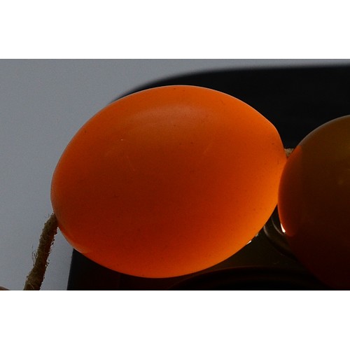 54 - A Bakelite beaded necklace, graduating size beads, largest bead 22mm, screw closure, 95cm, 65g