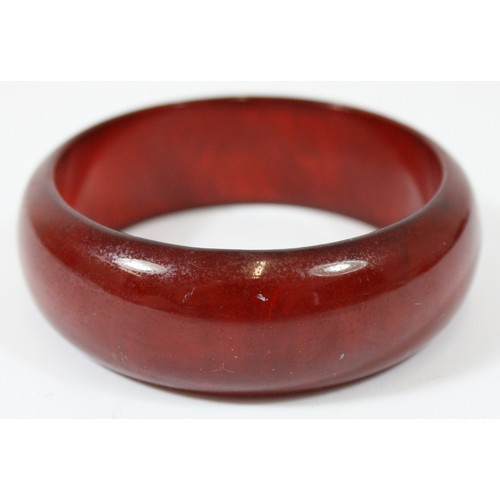 55 - A cherry Bakelite bangle, 65mm, 25mm wide