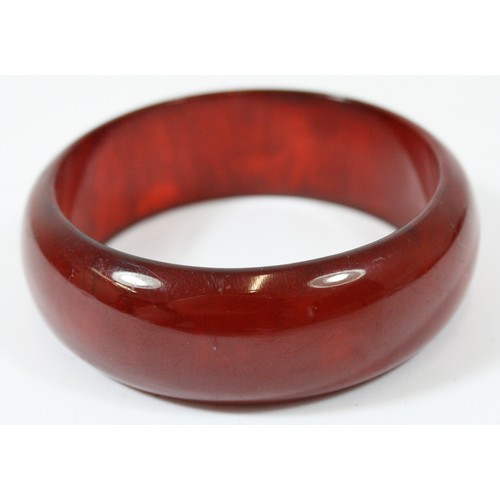 55 - A cherry Bakelite bangle, 65mm, 25mm wide