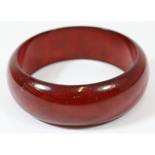 55 - A cherry Bakelite bangle, 65mm, 25mm wide