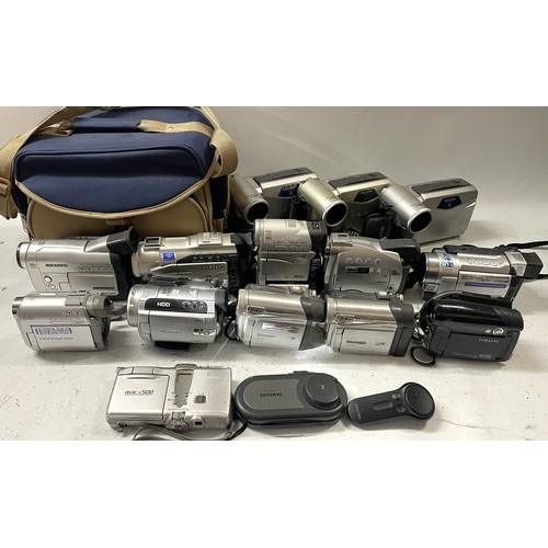 12 - A box of camcorder cameras to include a Sony Handycam DCR-HC30E, a Samsung VP-DC161WB, a Canon MV20 ... 