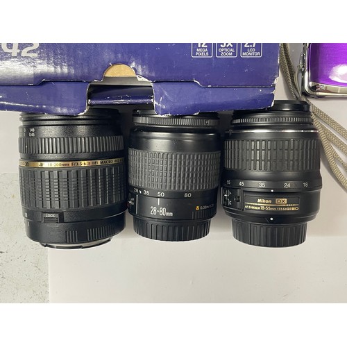 20 - A box of digital cameras and lens to include a Panasonic Lumix DMC-ZS1, a FujiFilm FinePix Z70, an O... 