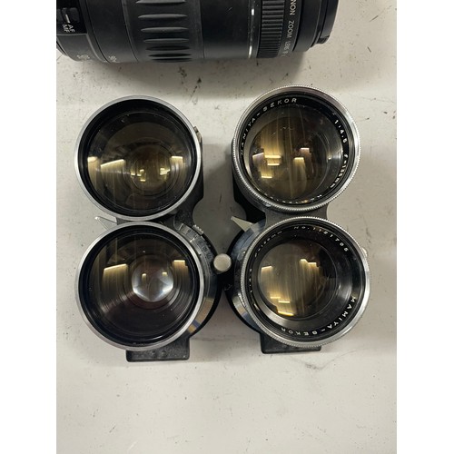 23 - A box of camera lens to include a Yashica 1:5.6 300mm lens, a Sigma 1:4.5 70-210mm lens, a CanonEF 5... 