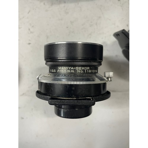 23 - A box of camera lens to include a Yashica 1:5.6 300mm lens, a Sigma 1:4.5 70-210mm lens, a CanonEF 5... 