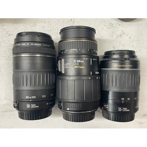 23 - A box of camera lens to include a Yashica 1:5.6 300mm lens, a Sigma 1:4.5 70-210mm lens, a CanonEF 5... 