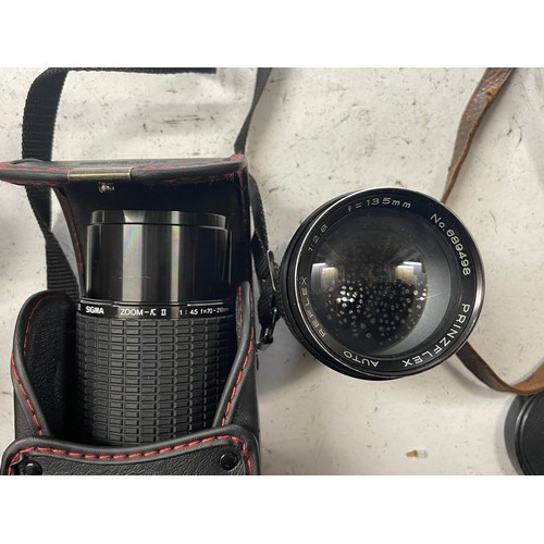 23 - A box of camera lens to include a Yashica 1:5.6 300mm lens, a Sigma 1:4.5 70-210mm lens, a CanonEF 5... 