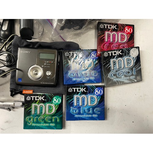 29 - A Sony Mini Disc Walkman MZ-NH900 and a box of camera accessories. (1 box)