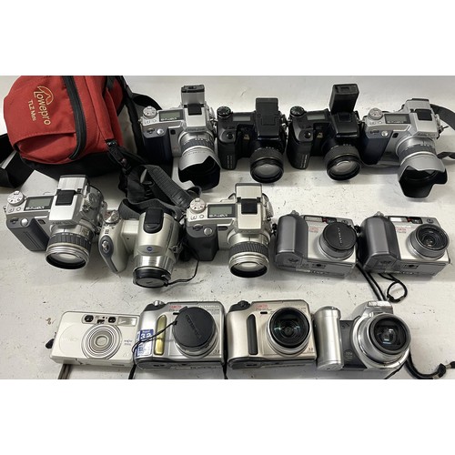 43 - A collection of digital cameras to include, an Olympus C-720,an Olympus C-730 and a Minolta DiMage 7... 
