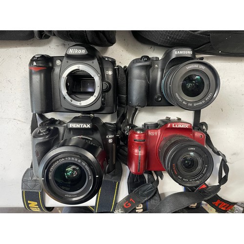 52 - A collection of digital cameras to include, a Samsung NX30, a Panasonic Lumix G1 and a Nikon D56. (O... 