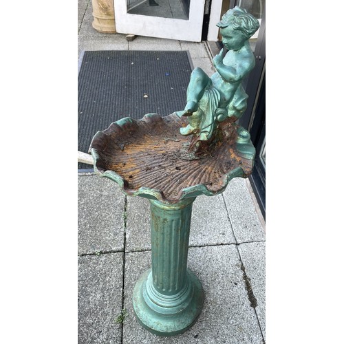 6 - A cast iron bird bath, featuring seated cherub, in need of repair to reattach top, height 94cm.