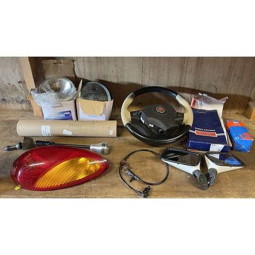 16 - A collection of car parts, predominately late classic Mini parts to include, part exhaust system inc... 