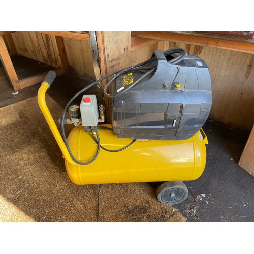 21 - A Powercraft compressor, 240v, 13a, comes with hose and accessories, together with a nail gun. (2)