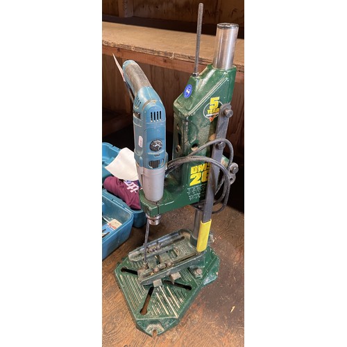26 - Two Makita power tools to include, a Makita hammer drill model number HP2071F mounted in a Record po... 