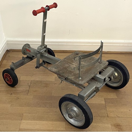 31 - A mid twentieth century child's hand powered rolling cart utilising a push-pull mechanism featuring ... 